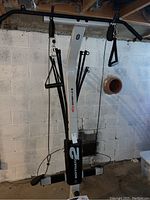 Front view of Bowflex Motivator 2 showing pulleys, handles, and resistance rods attached to the frame