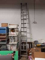 Photo of the full length of the 24-foot aluminum ladder standing upright, showing the extension feature and rungs.