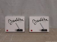 Two sealed Buddha Board art sets in white box packaging shown front side with logo and product image.