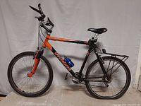 Full side view of Specialized Rockhopper mountain bike showing frame, wheels, and attached accessories.