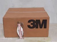 Closed cardboard shipping box with large 3M logo.