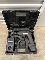 Overview of cordless drill, charger, and case with components placed inside case