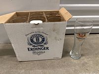 Six Erdinger branded beer glasses in original box, showing unopened packed glasses.