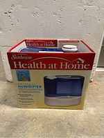 Boxed Sunbeam Health at Home ultrasonic humidifier front view