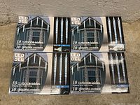Photo of five boxes of LED DEL outdoor icicle LED light strings, each with 10 dripping icicles shown on packaging.