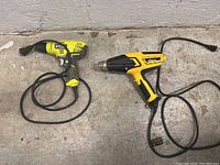 Both tools pictured on concrete surface showing full cords and main bodies.