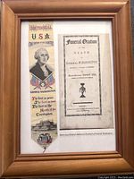 Framed wooden frame containing woven silk George Washington bookmark and printed Funeral Oration.