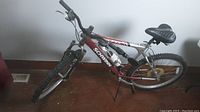 Full side view of the Schwinn mountain bike leaning against wall indoors