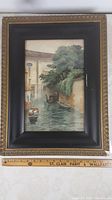Framed watercolour showing full Venetian canal scene with boats and trees