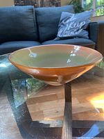 Side view of signed art glass bowl showing its shape and gradient color.