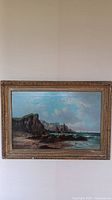 Full frontal view of the seascape painting in decorative carved frame