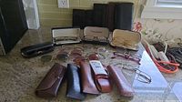 Wide view showing all sunglasses and eyeglass frames arranged with cases on countertop