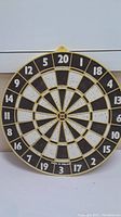 Full view of the dartboard showing numbering, segment colors, and made in England marking.