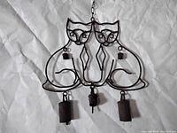 Photo of metal cat wire wind chime showing two cats and hanging chimes.