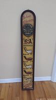 Tall vertical vintage golf golf club sign with mounted metal golf club replicas and vintage inscriptions.