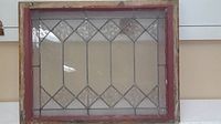 Full front view showing entire stained glass panel in wooden frame