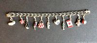 Full view of sterling silver charm bracelet with eleven colorful crystal-decorated charms
