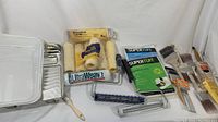Full view of the paint items including trays, rollers, brushes, and protective sheets.