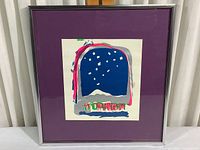 Framed abstract artwork in blue, silver, pink, green, and white with purple mat and silver metal frame, showing full view of the piece.