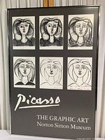 Full front view of framed poster showing six black and white sketches and printed text