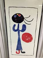 Close-up of colorful Joan Miró woodcut print with abstract shapes.