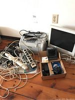 Overview of all items together including printer, monitor, power bars, cables, and accessories.