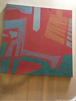 Front view of abstract painting showing geometric shapes in red, teal, gray, and orange colors