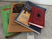 Four Sherlock Holmes themed books stacked, showing their covers with titles and cover art.
