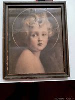 Straight view of framed art showing the portrait of Child Jesus with halo in a dark wooden frame.