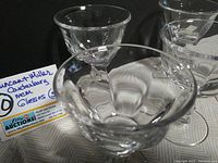 Photo showing five clear vintage Dunkin & Miller Canterbury liquor/cocktail glasses arranged on a surface with a note indicating the lot details.