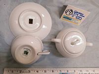 Photo showing bottom markings on Crown Bavaria saucer plate and Princess Heritage Bavaria tea cup, with sugar bowl lid and body visible.