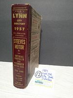 Side view of the maroon hardcover city directory book showing the spine with title and publisher details.