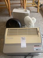 Photo of all fans and one Oreck air purifier from the front showing size and condition.