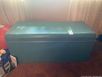Front view of painted teal Lane cedar chest with lid closed, showing general shape and finish.