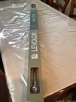 Full view of the curtain rod in original packaging showing Levolor branding and measurement range.