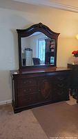 Full front view of the dresser with mirror, showing the entire piece and its position in the room.