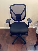 Front view of black mesh office chair with cushioned seat and armrests on caster base