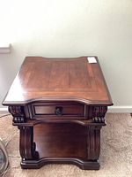 Overall side view showing the shape, drawer, and bottom shelf