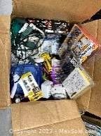 Open box view showing assorted hand tools and small packaged hardware items inside the cardboard box.