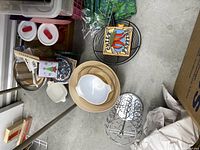 Top view of assorted items including white bowls, wire trivets, and containers.