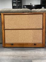 Full front view of cork board showing two rectangular cork panels separated by a wood divider inside a rustic wood frame.