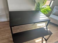 Top view of espresso wood finish dining table showing rectangular shape and metal frame.