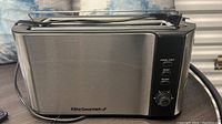 Photo of Elite Gourmet stainless steel 4-slice toaster showing control buttons and rotary browning knob.