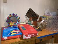 Various office supplies on wooden desk including file organizers, decorative item, papers, and other supplies
