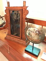 Whole lot showing both vintage wooden clock and convex mirror on stand.