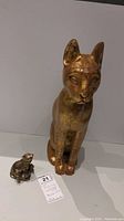 Tall wooden cat figurine standing upright with gold and red paint, 17 inches high