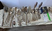 Full view of the collection laid out showing all pieces of serving cutlery including spoons, forks, scissors, and salt/pepper shakers.