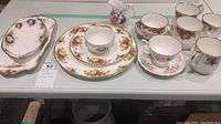 Full set including plates, cups, mugs, saucers, creamers with floral and gold pattern