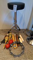 Full view of adjustable music stool with various percussion instruments and accessories arranged at base