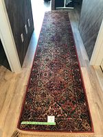 Overhead view of long runner rug in hallway showing full length and pattern.